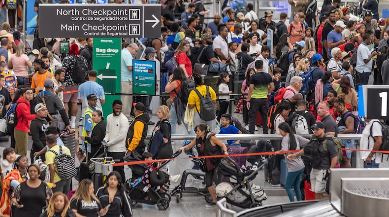 Travelers at Hartsfield-Jackson International Airport crowd around ticket counters on July 19, as a massive outage triggered by a security update from CrowdStrike affected Microsoft users around the globe, disrupting airlines, railways, banks, stock exchanges and other businesses. (John Spink/AJC 2024)