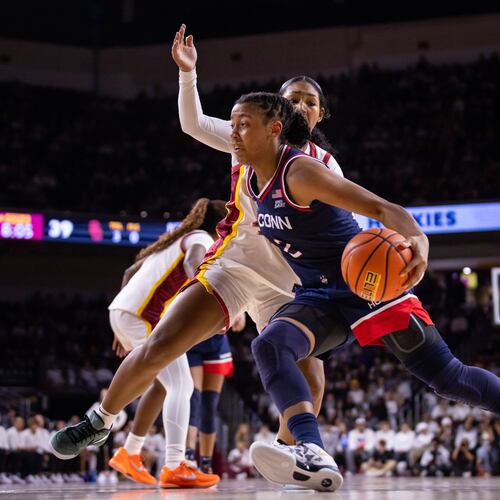 UConn guard Kk Arnold (2) drives the ball against Southern California during the second half of an NCAA college basketball game Saturday, Dec. 13, 2025, in Los Angeles. (AP Photo/Ethan Swope)