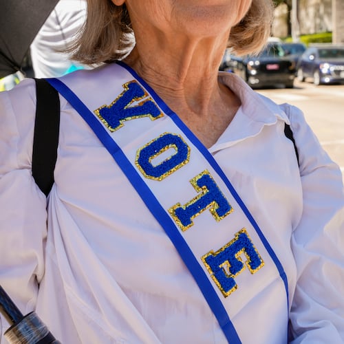 Protestor, Linda James, poses for photo with her "VOTE" sash at the Dallas March on the RNC Midterm Convention in Dallas, Thursday, Sept. 10, 2026. (AP Photo/Gabriela Passos)