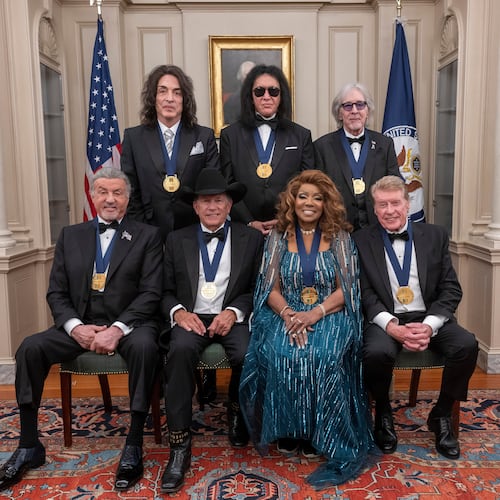 The 2025 Kennedy Center Honorees, front row from left, Sylvester Stallone, George Strait, Gloria Gaynor and Michael Crawford; back row from left, members of the rock band KISS, Paul Stanley, Gene Simmons and Peter Criss, pose for a group photo at the 48th Kennedy Center Honors Medallion Reception, hosted at the U.S. Department of State, Saturday, Dec. 6, 2025 in Washington. (AP Photo/Kevin Wolf)