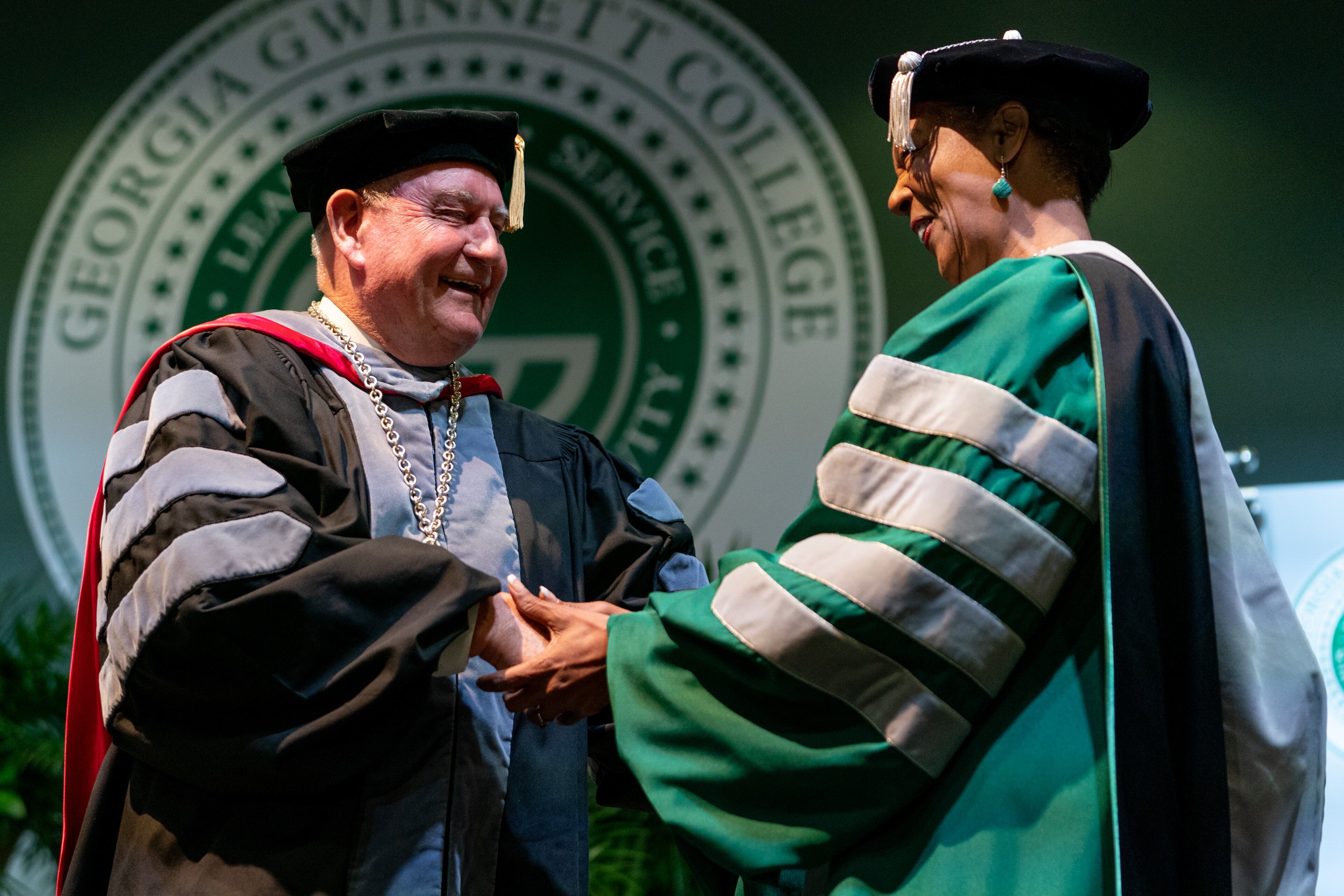 University System of Georgia Chancellor Sonny Perdue shakes hands with Georgia Gwinnett College President Jann L. Joseph during her investiture ceremony, on Friday, April 1, 2022, in Lawrenceville. (Elijah Nouvelage/Special to the Atlanta Journal-Constitution)
