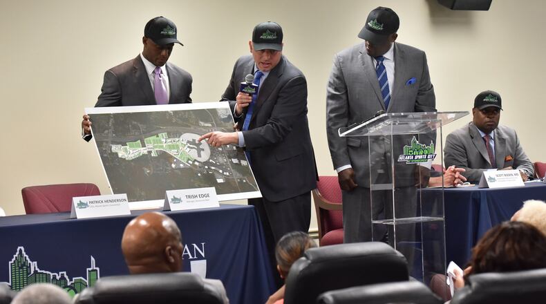 Craig Delasin (center), CEO of Urban Retail Properties, explains as Patrick Henderson (left), CEO of Atlanta Sports Connection, and Zeric Foster, COO of Atlanta Sports Connection, stand next him during a press conference on May 17, 2017. Developers and tourism officials revealed plans for medical facilities and retail at Atlanta Sports City. HYOSUB SHIN / HSHIN@AJC.COM