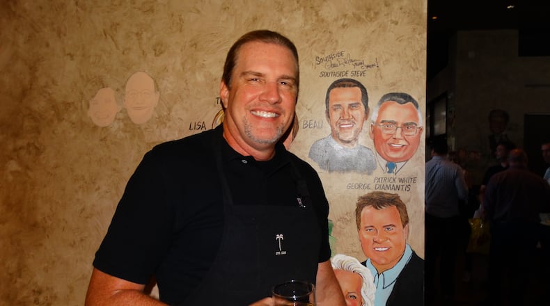 "Southside" Steve Rickman gets a caricature, but he noticed immediately that his ponytail is not included. They plan to add one. "It's my signature," he said. CREDIT: Rodney Ho/rho@ajc.com