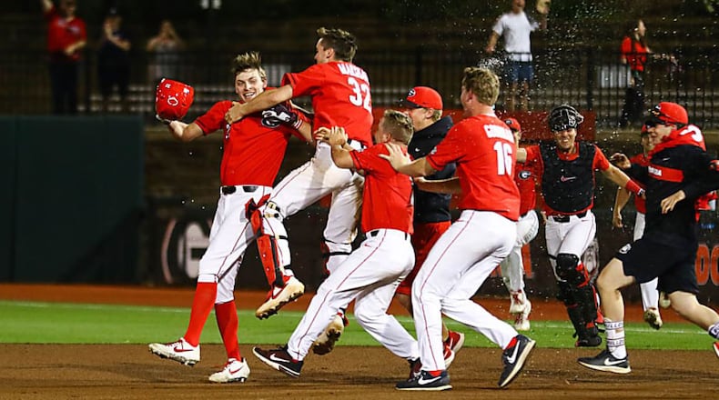 Georgia players celebrate with Connor Tate after Tate's single ended the longest game in UGA and Clemson history at 1:35 a.m. Wednesday. (Kristin M. Bradshaw/UGA Sports)