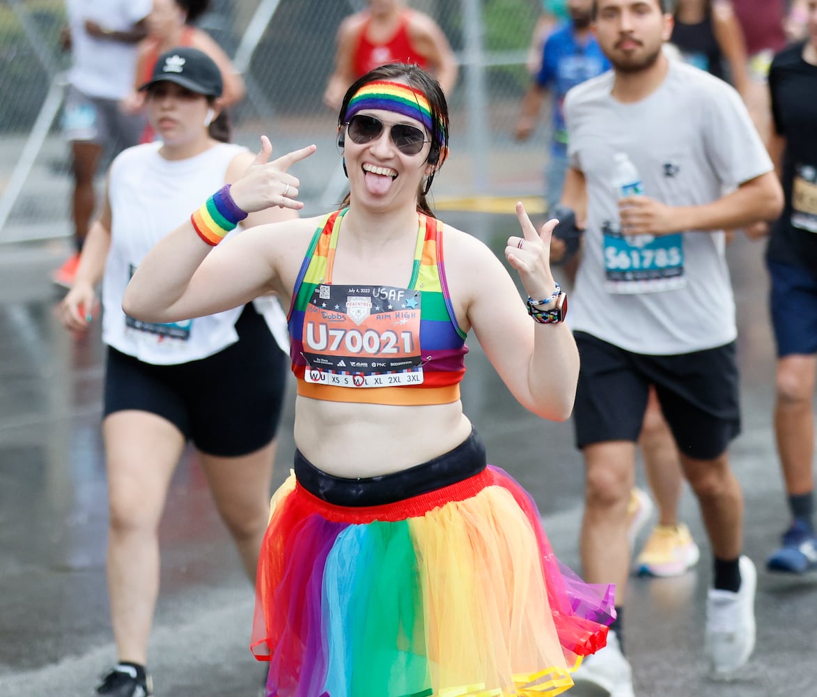 Runners make their way up Peachtree Street during the 54th running of the Atlanta Journal-Constitution Peachtree Road Race in Atlanta on Tuesday, July 4th, 2023.   (Miguel Martinez / Miguel.MartinezJimenez@ajc.com)