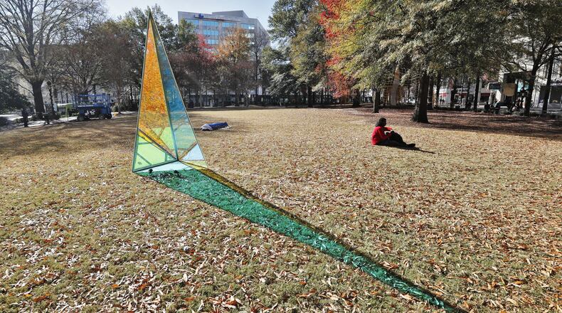 This light-shifting sculpture by David Baerwalde and Alex Martinez is part of the public art installation “PRISM: Winter Lights at Woodruff Park.”   The exhibit spreads throughout the downtown park, enhancing existing landmarks like the International Peace Fountain and the iconic gazebo with geometric sculptures, "upcycled" lights, and a light garden.  Bob Andres / bandres@ajc.com