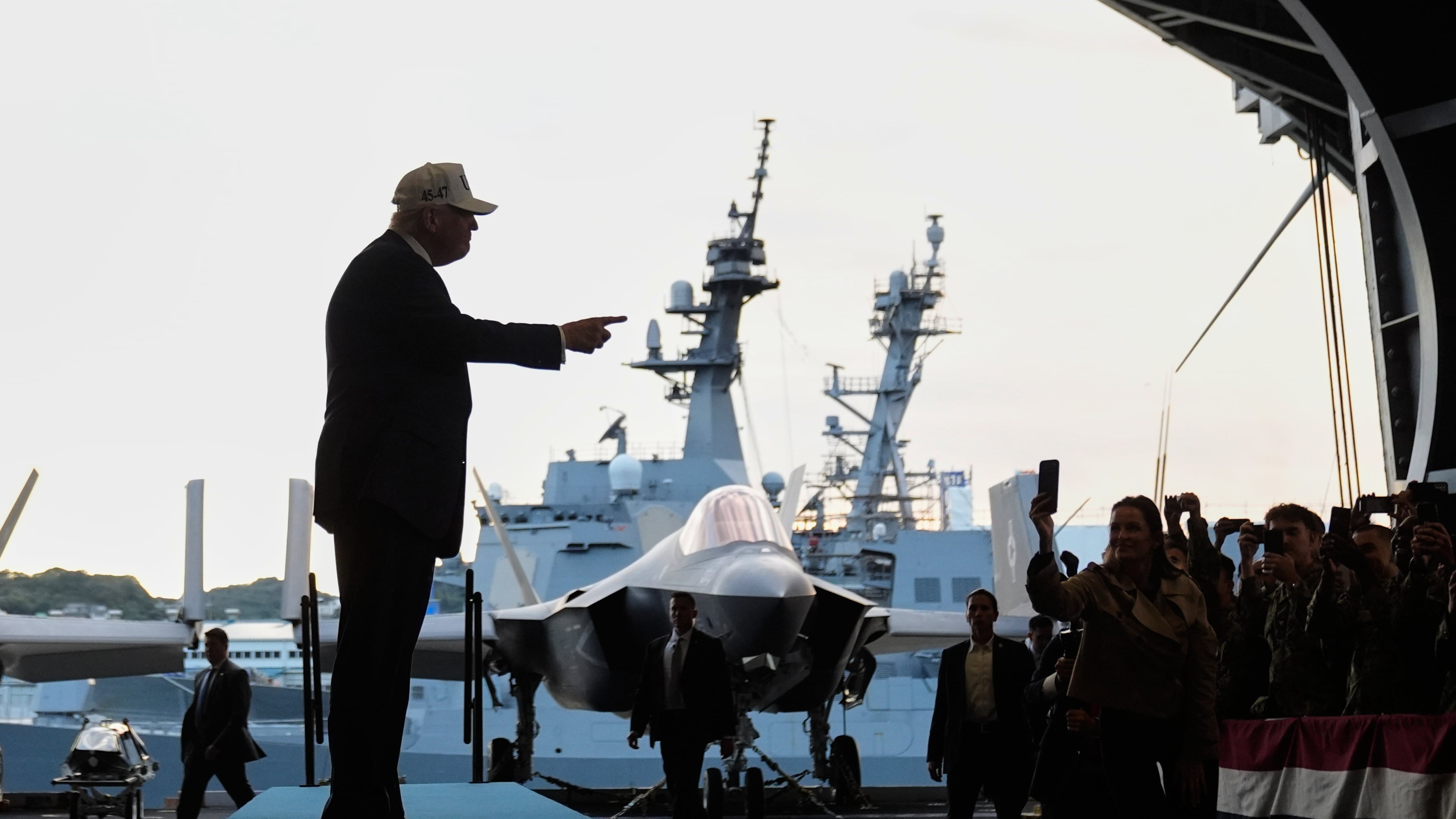 President Donald Trump gestures as he walks towards the stage before speaking to members of the military aboard the USS George Washington, an aircraft carrier docked at an American naval base, in Yokosuka, Tuesday, Oct. 28, 2025. (AP Photo/Mark Schiefelbein)
