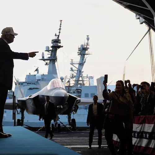 President Donald Trump gestures as he walks towards the stage before speaking to members of the military aboard the USS George Washington, an aircraft carrier docked at an American naval base, in Yokosuka, Tuesday, Oct. 28, 2025. (AP Photo/Mark Schiefelbein)
