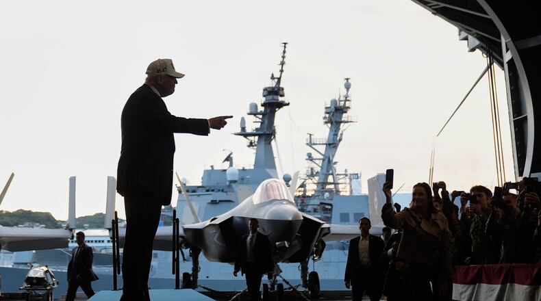 President Donald Trump gestures as he walks towards the stage before speaking to members of the military aboard the USS George Washington, an aircraft carrier docked at an American naval base, in Yokosuka, Tuesday, Oct. 28, 2025. (AP Photo/Mark Schiefelbein)