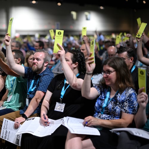 Attendees hold up their ballots while voting on a motion during the annual meeting of the Southern Baptist Convention, Tuesday, June 9, 2026, in Orlando, Fla. (AP Photo/Phelan M. Ebenhack)