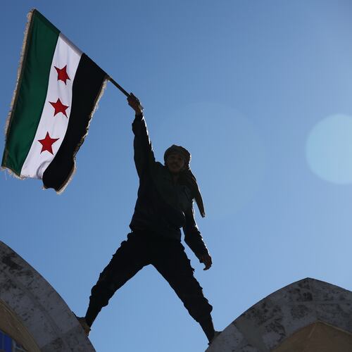 FILE - A soldier waves a Syrian flag amid celebrations a day after Syrian government troops took control of Raqqa from the Syrian Democratic Forces (SDF), at Al-Naeem roundabout in central Raqqa, northeastern Syria, Monday, Jan. 19, 2026. (AP Photo/Ghaith Alsayed, File)