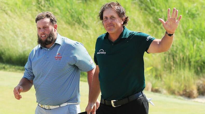 Andrew 'Beef' Johnston of England (L) and Phil Mickelson of the United States acknowledge the crowd on the 18th green during the third round of the 2018 U.S. Open at Shinnecock Hills Golf Club on June 16, 2018 in Southampton, New York. (Photo by Andrew Redington/Getty Images)