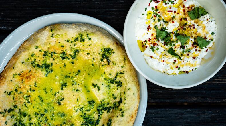 Creamy stracciatella is served with a freshly baked flatbread at No. 246 in Decatur. CONTRIBUTED BY HENRI HOLLIS