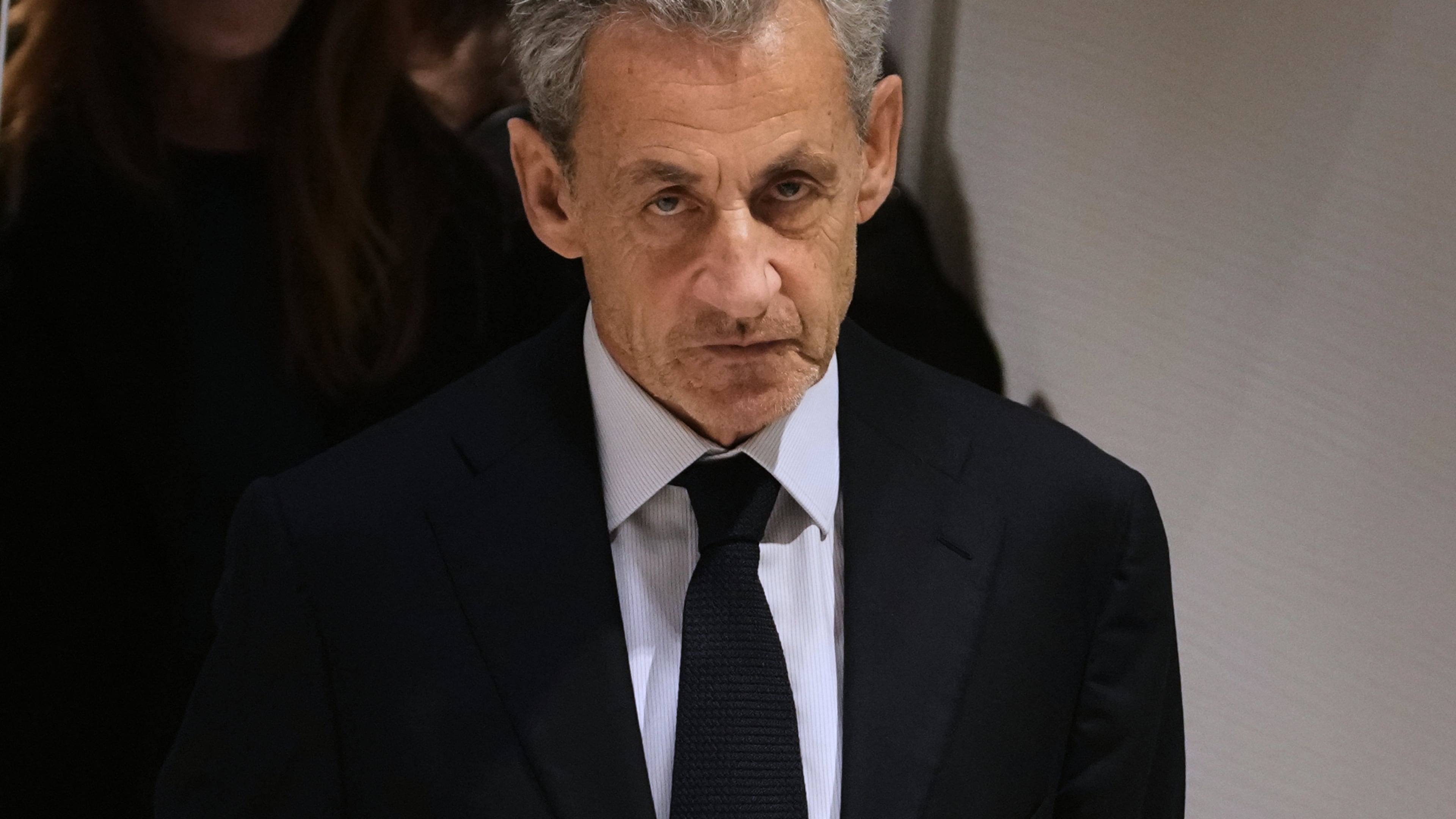 FILE- Former French President Nicolas Sarkozy leaves after a Paris court sentenced him to 5 years after finding him guilty of criminal conspiracy in an alleged scheme to finance his 2007 campaign with funds from Libya, Thursday, Sept. 25, 2025 in Paris. (AP Photo/Christophe Ena, File)