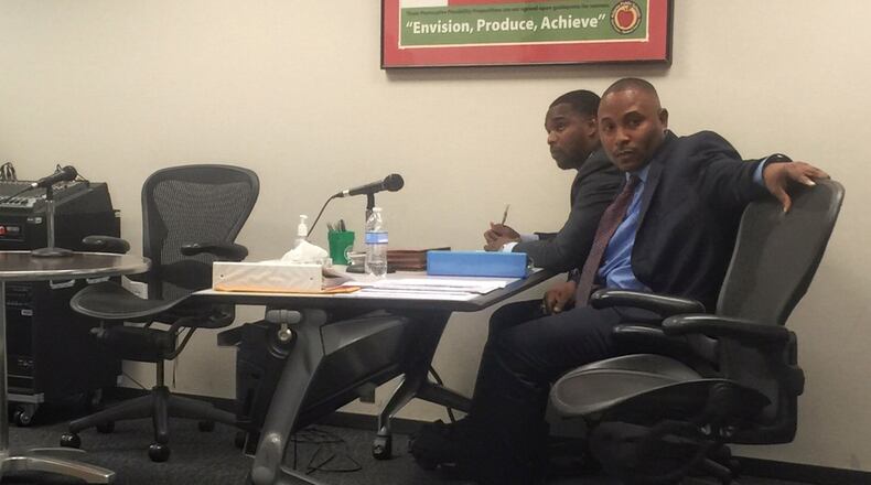 Mays High School football coach Corey Jarvis (right) at a personnel hearing. Molly Bloom/AJC