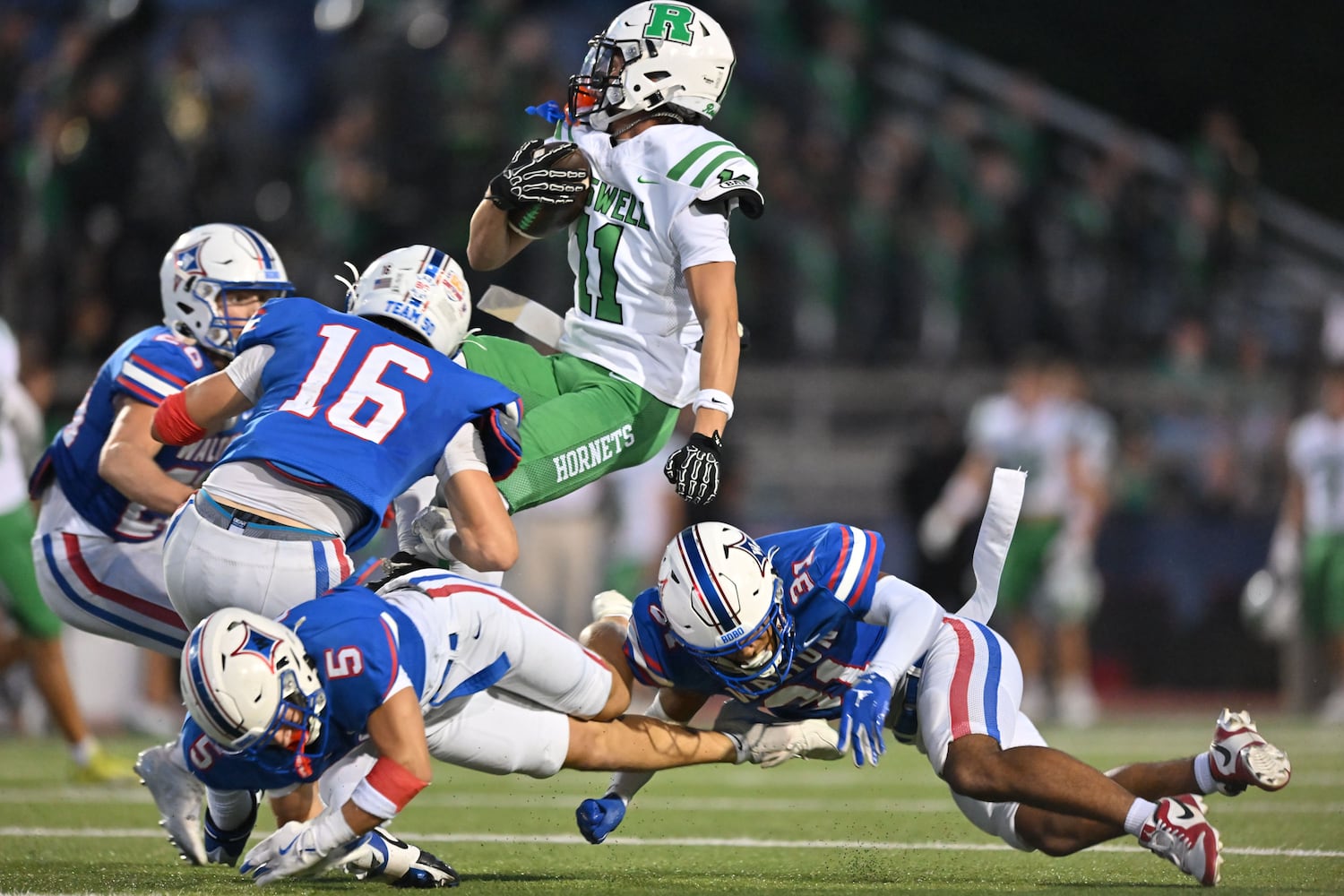Walton’s defense makes a tackle on Roswell wide receiver Chase Shaffer (11) as he runs the ball during the first half of a game Friday, August 29, 2025 at Walton High School. (Daniel Varnado/For the Atlanta Journal-Constitution)