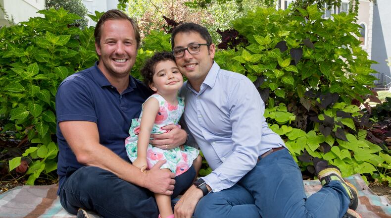 Derek Mize, left, and Jonathan Gregg, right, have won a legal battle with the U.S. State Department for their daughter, Simone Mize-Gregg, 2, to be declared a U.S. citizen and issued a passport. The legal battle may not be over, though.  (Jenni Girtman for The Atlanta Journal-Constitution)