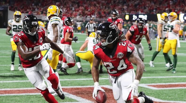 Falcons running back Devonta Freeman scores a touchdown for a 14-7 lead over the Packers during the second quarter Sunday night. The Falcons' offense clicked in Week 2 after struggling in the season opener. (Curtis Compton/ccompton@ajc.com)