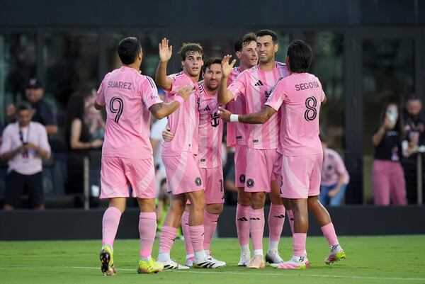 FILE - Teammates celebrate with Inter Miami forward Lionel Messi (10), center, after he scored his side's second goal against Columbus Crew during the first half of an MLS soccer match, Saturday, May 31, 2025, in Fort Lauderdale, Fla. (AP Photo/Rebecca Blackwell, File)