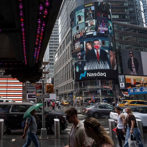 People walk past the Nasdaq MarketSite, Thursday, Aug. 6, 2026, in New York. (AP Photo/Yuki Iwamura)