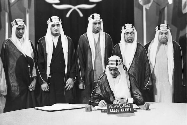 FILE - Saudi Arabia's Minister of Foreign Afairs Prince Faisal bin Abdul Aziz Al-Saud signs the United Nations Secuity Charter, in San Francisco, June 26, 1945, as members of the Saudi Arabian delegation watch. (AP Photo, File)