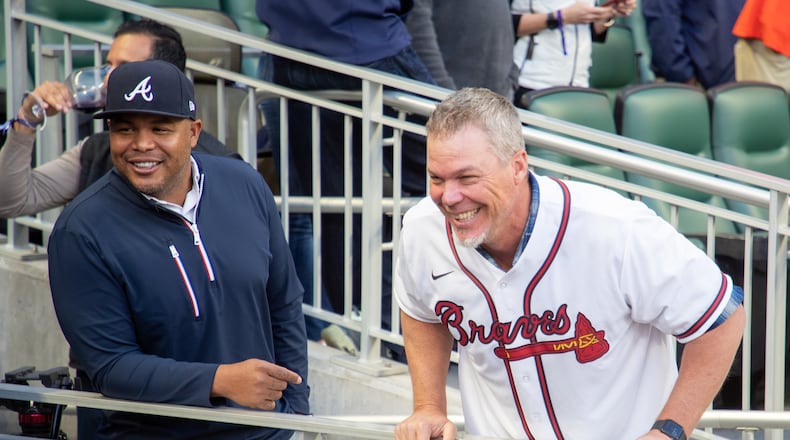 Andruw Jones (R) and Chipper Jones talk with the players before the start of the opening season game with the Cincinnati Reds at Truist Park Thursday, April 7, 2022 (Steve Schaefer / steve.schaefer@ajc.com)