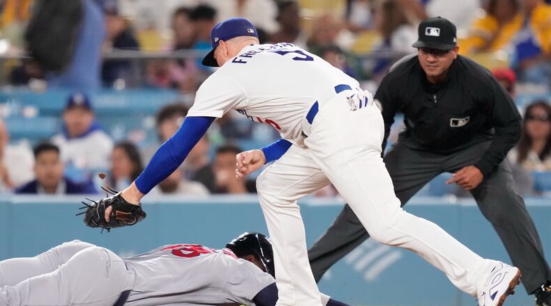 St. Louis Cardinals' Jordan Walker, left, is tagged out at first by Los Angeles Dodgers first baseman Freddie Freeman after being caught off base during the fifth inning of a baseball game Thursday, Sept. 3, 2026, in Los Angeles. (AP Photo/Mark J. Terrill)