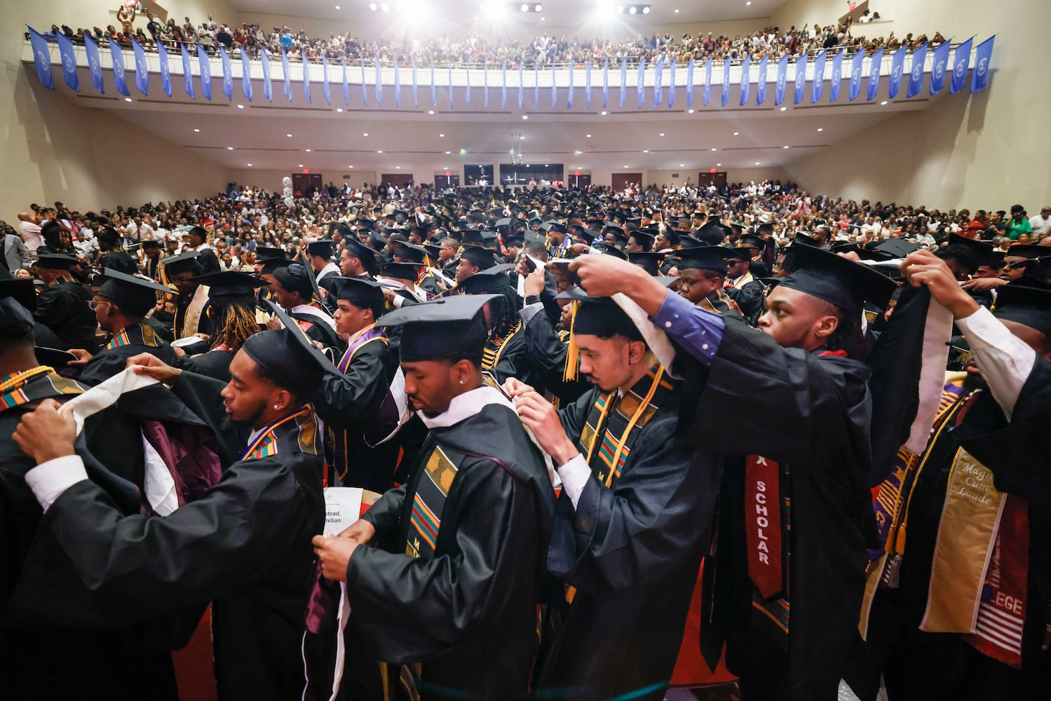 Graduates helped each other don hoods at Morehouse College's 141st Commencement Ceremony on Sunday, May 18, 2025.
(Miguel Martinez/ AJC)