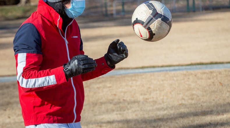 Lin Xin is trying to stay warm while practicing his soccer skills on Christmas morning in Piedmont Park on December 25, 2020. STEVE SCHAEFER FOR THE ATLANTA JOURNAL-CONSTITUTION