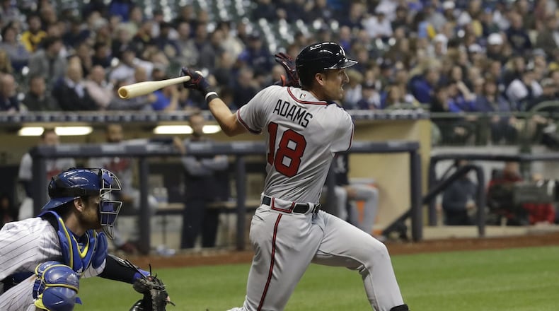 Braves outfielder Lane Adams, pictured hitting a single in Milwaukee on April 28, played in games for Triple-A Gwinnett on Wednesday afternoon and Atlanta on Wednesday night. (AP Photo/Morry Gash)