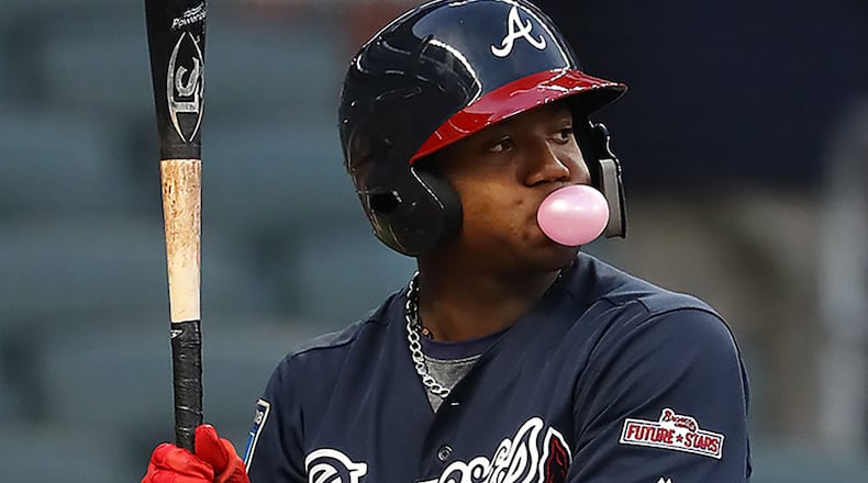 Braves outfielder Ronald Acuna Jr., blows a bubble while he bats during the first inning in the Future Stars Exhibition Game Tuesday, March 27, 2018, at SunTrust Park.