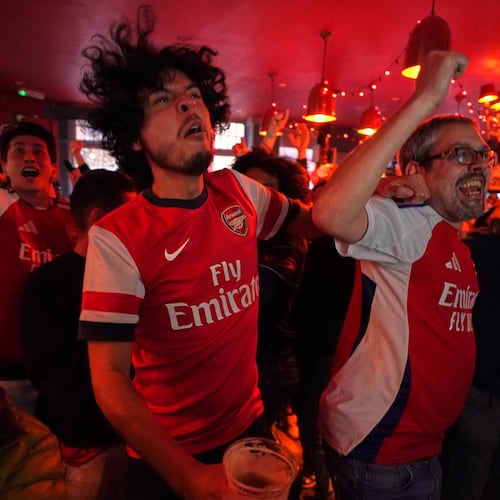 Arsenal supporters celebrate as they watch the Premier League match between Bournemouth and Manchester City in a pub near the Arsenal stadium in London, Tuesday, May 19, 2026.(AP Photo/Alberto Pezzali)
