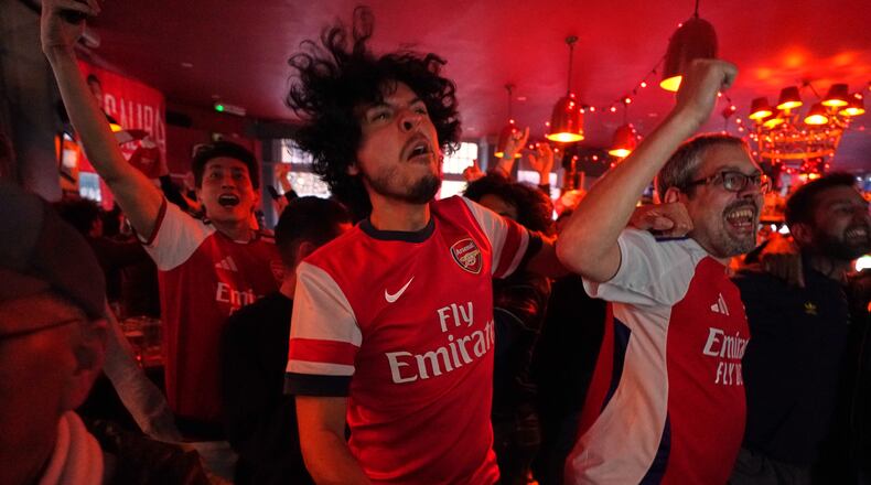 Arsenal supporters celebrate as they watch the Premier League match between Bournemouth and Manchester City in a pub near the Arsenal stadium in London, Tuesday, May 19, 2026.(AP Photo/Alberto Pezzali)