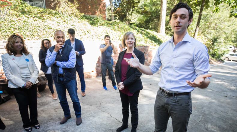 Democratic candidate for 6th District Lucy McBath (L-R), former Governor of Massachusetts Deval Patrick, and Sally Harrell, who is running for a Dunwoody-based state Senate district, listens as Jon Ossoff speaks to campaign volunteers and supporters, Saturday, Oct. 13, 2018, in Atlanta