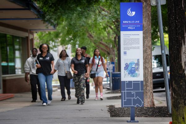 Georgia State University has placed trail markers like this one near Student Center East. The markers include QR codes that students can scan with their smartphones to find an online map or call for help. (Georgia State University)