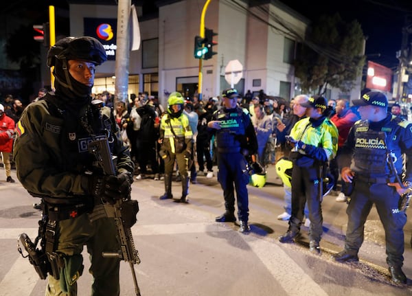 Police stand guard outside the Medicentro hospital where Colombian senator and presidential candidate Miguel Uribe Turbay is being treated after he was shot during a campaign rally in Bogota, Colombia, Saturday, June 7, 2025. (AP Photo/Jhon Wilson Vizcaino)