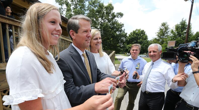 Secretary of State Brian Kemp, with his wife Marty and daughter Jarrett, at a July campaign event in Winterville. Curtis Compton, ccompton@ajc.com
