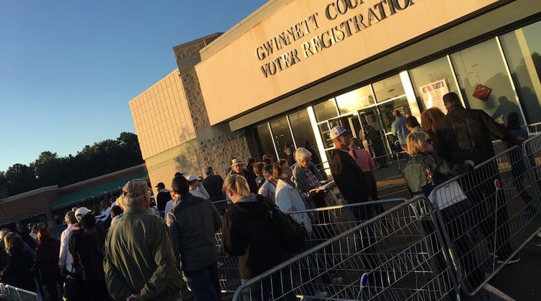 Hundreds of people lined up outside the Gwinnett County elections office for the first day of early voting earlier this month. TYLER ESTEP / TYLER.ESTEP@AJC.COM