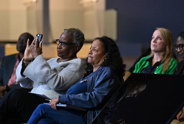 Attendees, including local advocate Gina Mangham (center), listen during a community meeting to discuss possible DeKalb school closures at New Life Church on Tuesday, April 28, 2026, near Decatur. (Hyosub Shin/AJC)