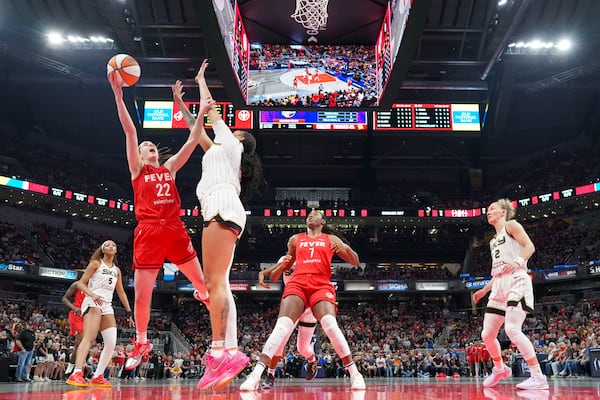Indiana Fever guard Caitlin Clark (22) shoots around Chicago Sky center Kamilla Cardoso (10) during the first half of an WNBA basketball game in Indianapolis, Saturday, May 17, 2025. (AP Photo/AJ Mast)