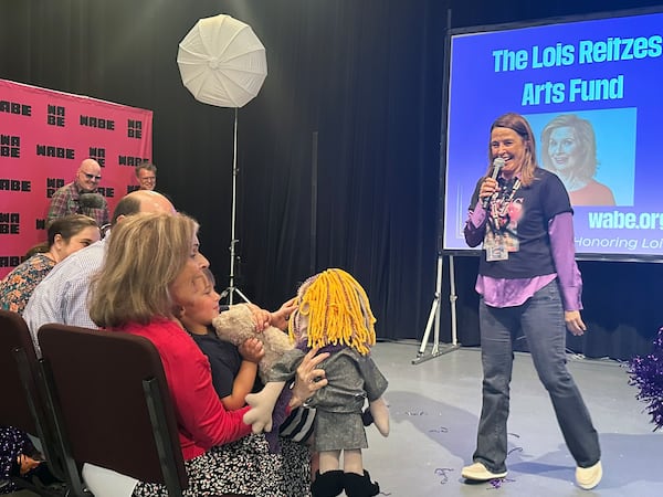 WABE executive director Jennifer Dorian presented Lois Reitzes a special Muppet as one of her retirement presents. (Rodney Ho/AJC)