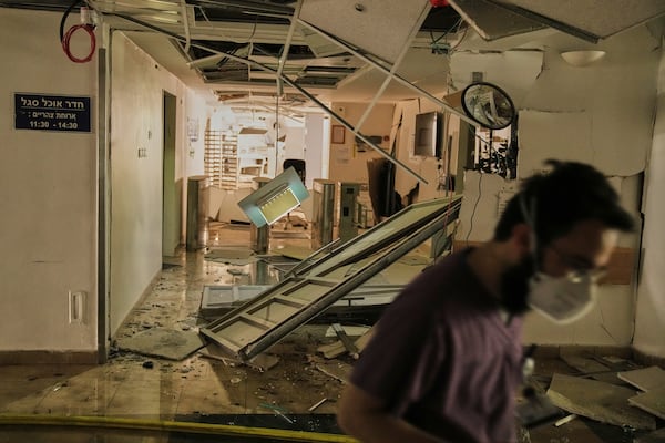 A medical staff walks along a damaged area at the Soroka hospital complex after it was hit by a missile fired from Iran in Be'er Sheva, Israel, Thursday, June 19, 2025. (AP Photo/Leo Correa)
