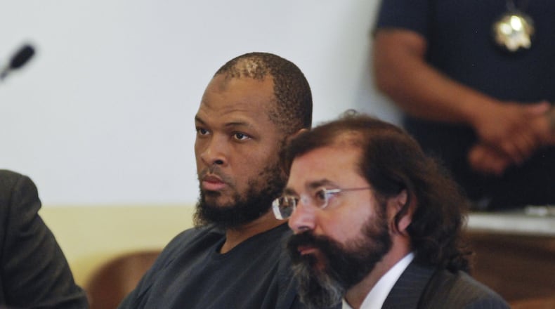 Siraj Ibn Wahhaj, left, sits next to public defense attorney Aleks Kostich at a first appearance in New Mexico state district court in Taos, N.M., Wednesday, Aug. 8, 2018, on accusations of child abuse and abducting his son from the boy’s mother. Authorities were waiting to learn if human remains found at a disheveled living compound were those of Wahhaj’s missing son. Authorities also allege Wahhaj was conducting weapons training with assault rifles at the compound near the Colorado border where they say they found 11 hungry children living in filthy conditions in a raid Friday. (AP Photo/Morgan Lee)
