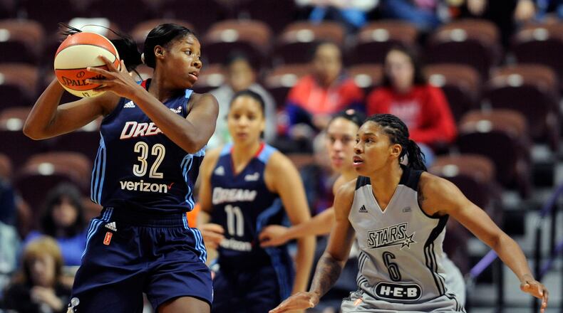 Bria Holmes of the Dream looks to pass around Alex Montgomery, right, of San Antonio during the second half of a WNBA basketball game, Wednesday, May 4, 2016, in Uncasville, Conn. (AP Photo/Jessica Hill)