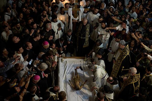 Catholic clergymen take part in a Good Friday ceremony reenacting the funeral of Jesus Christ at the Church of the Holy Sepulcher, the site where according to tradition Jesus was crucified and buried, in the Old City of Jerusalem on Friday, April 18, 2025. (AP Photo/Leo Correa)