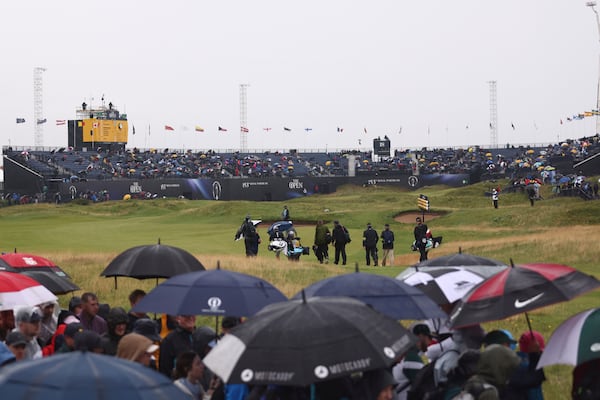 A general view of the 18th green as a group of players including Lee Westwood of England walk to the green during the first round of the British Open golf championship at the Royal Portrush Golf Club, Northern Ireland, Thursday, July 17, 2025. (AP Photo/Peter Morrison)