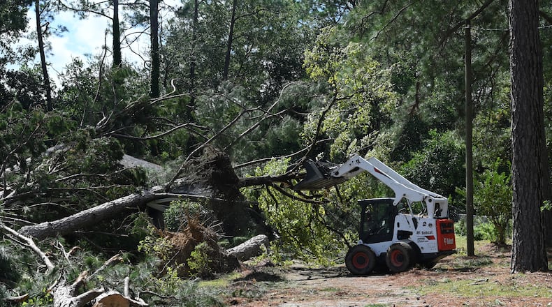 Crew cleans up fallen trees, where a man was killed by fallen trees caused by Hurricane Helene, Friday, September 27, 2024 in Dublin. Fast-moving Helene, which entered Georgia as a Category 2 hurricane Friday morning, continues its powerful march toward metro Atlanta. The storm, which made landfall as a Category 4 in Florida’s Big Bend region Thursday night with maximum sustained winds of 140 mph, continues to pack a dangerous punch and is responsible for at least three deaths in Georgia. Helene’s sustained winds are now at 70 mph, making it a tropical storm status, and it is quickly traveling north. (Hyosub Shin / AJC)