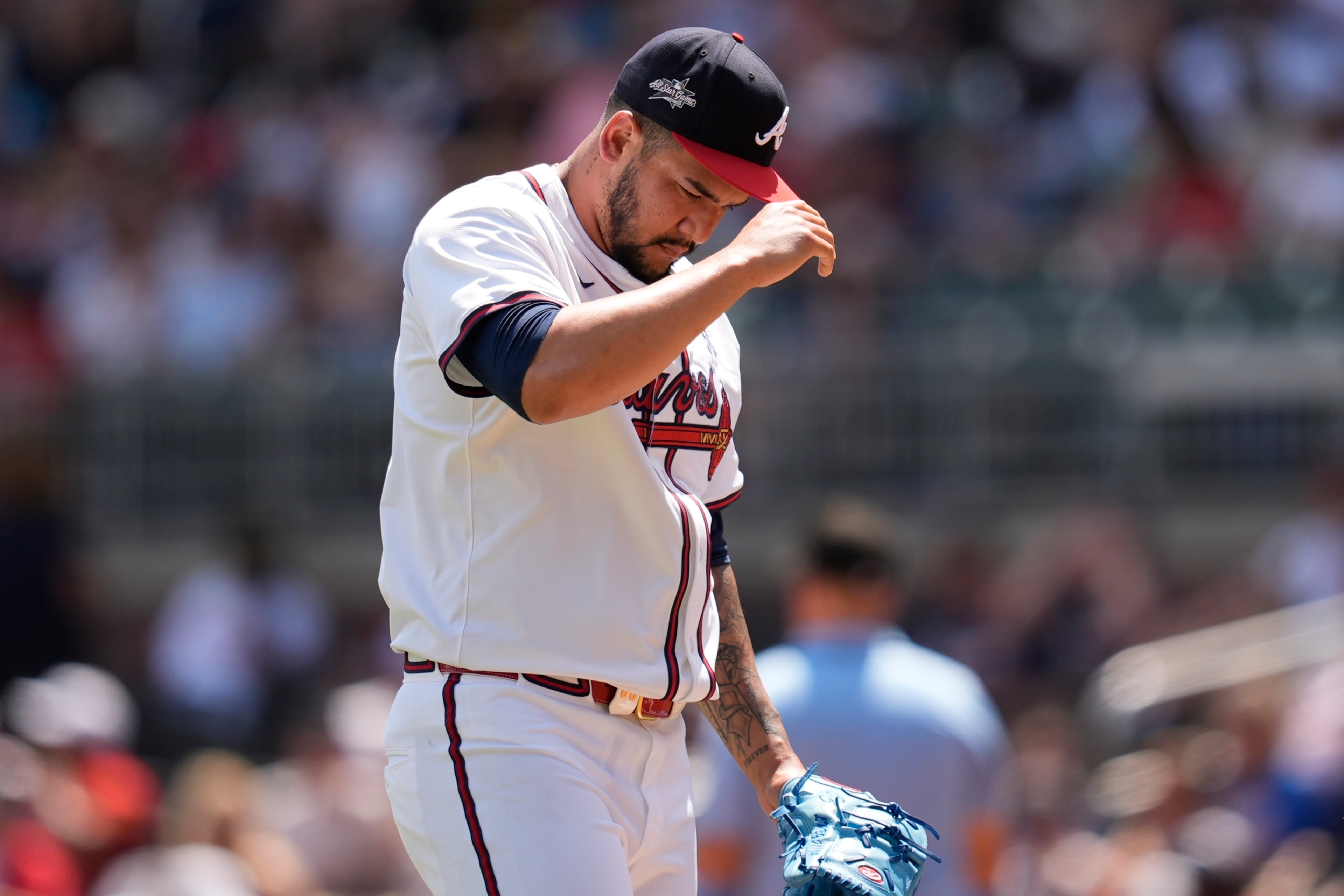 Atlanta Braves pitcher José Ruiz reacts after a balk scoring a run in the seventh inning against the Rockies on Sunday. (Mike Stewart/AP)