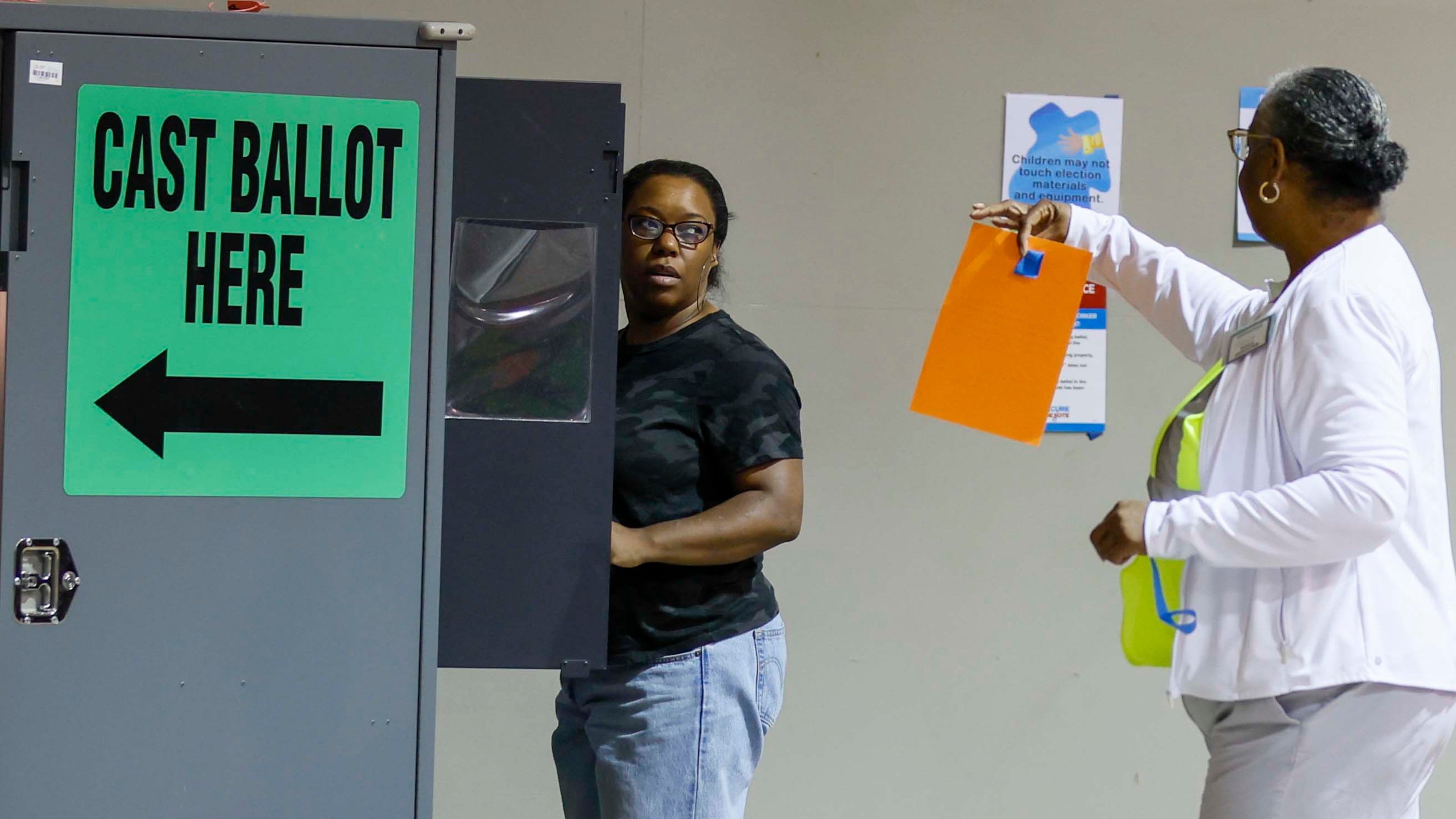 Felicia Hill from Mableton receives assistance from a poll worker during June's special election. Mandatory audits have confirmed that Georgia’s voting machines tabulate votes with near perfect accuracy. (Miguel Martinez/AJC)