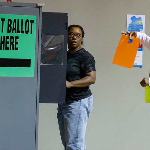 Felicia Hill from Mableton receives assistance from a poll worker at Calvary Baptist Church in Austell during the Georgia Public Service Commission’s special election on Tuesday, June 17, 2025. (Miguel Martinez/AJC)
